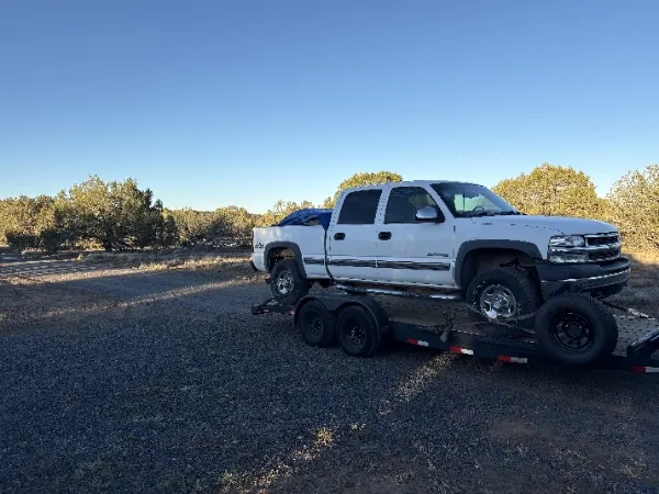 MYS Transportation truck towing a pickup in the desert